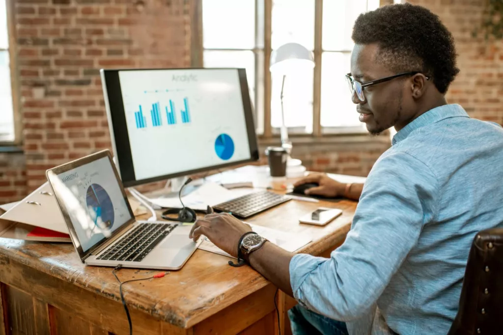 A black man analyzing his diverse real estate management portfolio